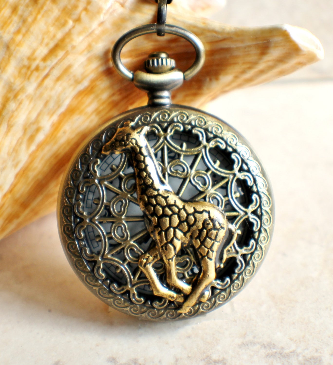 il_fullxfull.1012971289_j0b3.jpeg Giraffe battery operated pocket watch in bronze. - Image 1